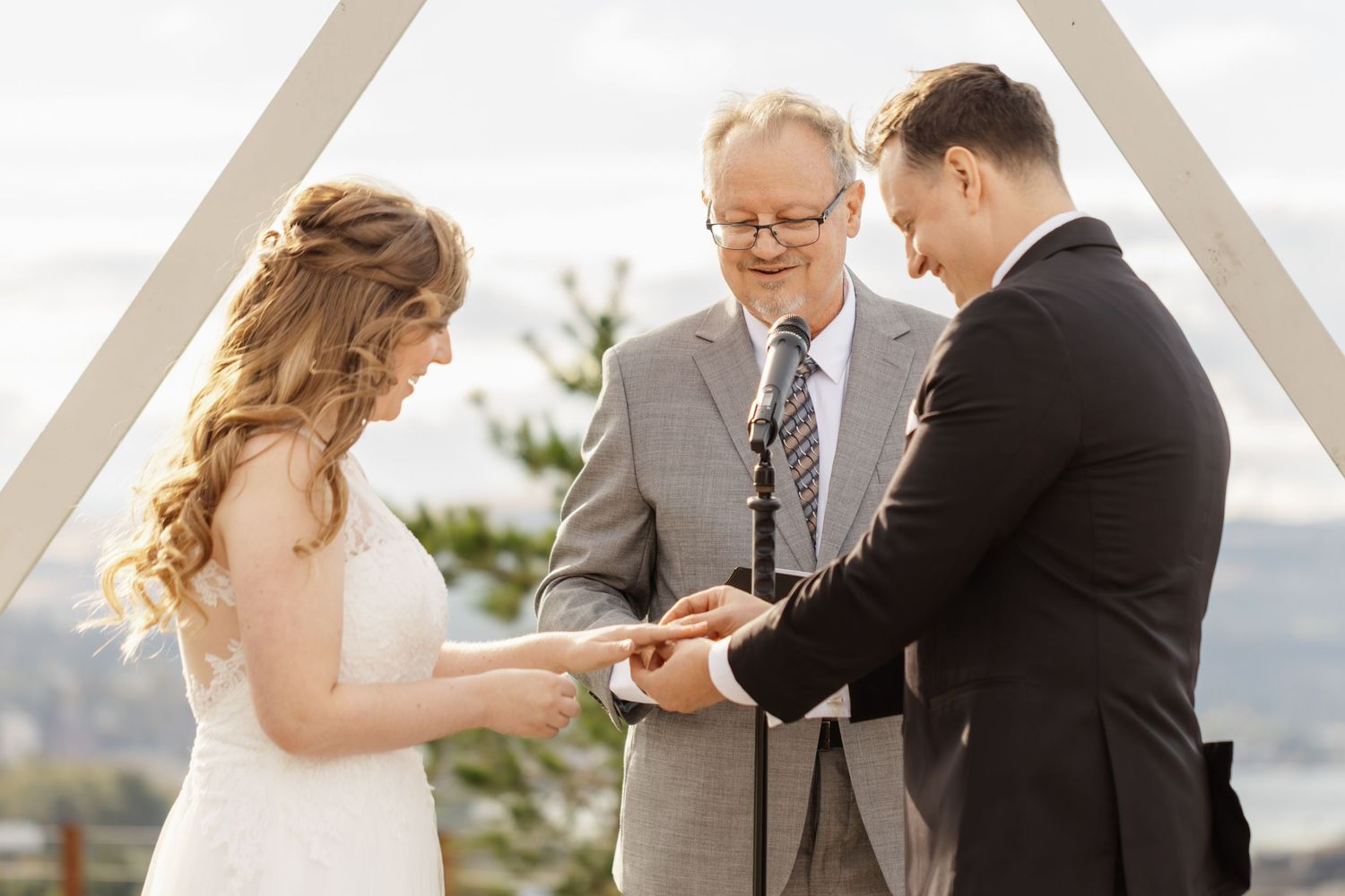 Outdoor wedding ceremony with scenic mountain views and elegant white decor.