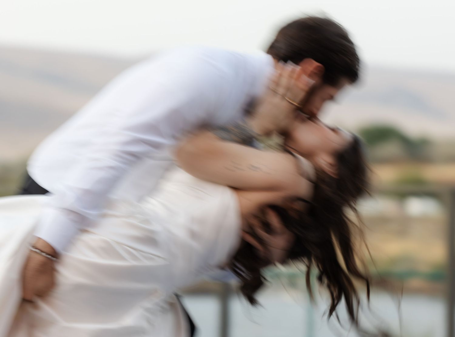 Motion blur sequence of a spinning wedding couple creating a dreamy effect.