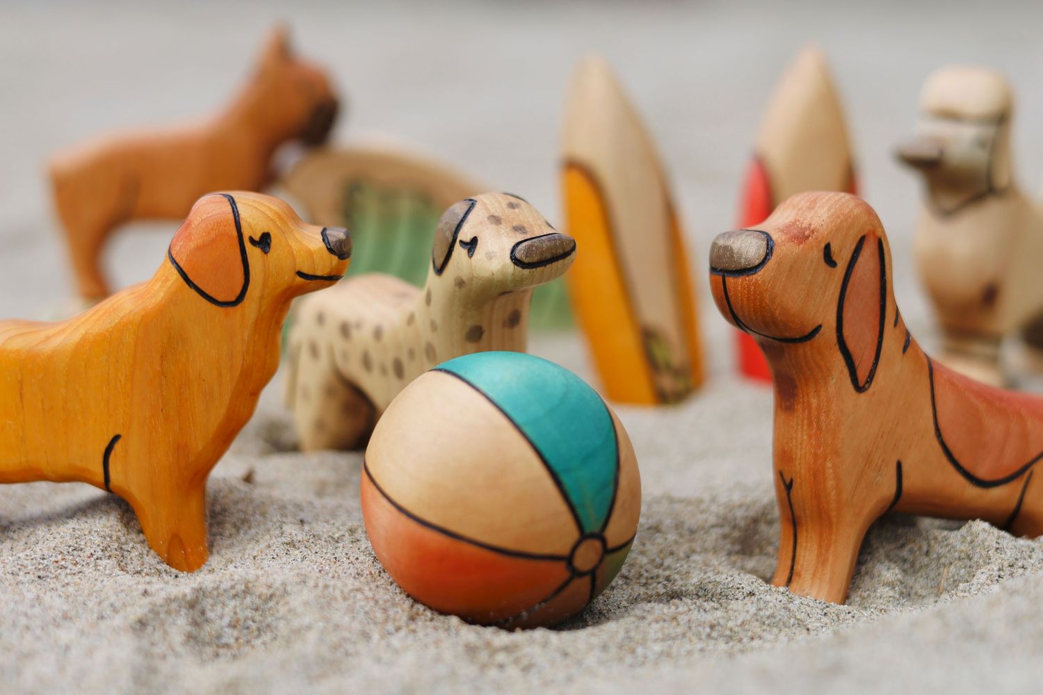 Collection of whimsical clay animal figurines arranged on a neutral surface.