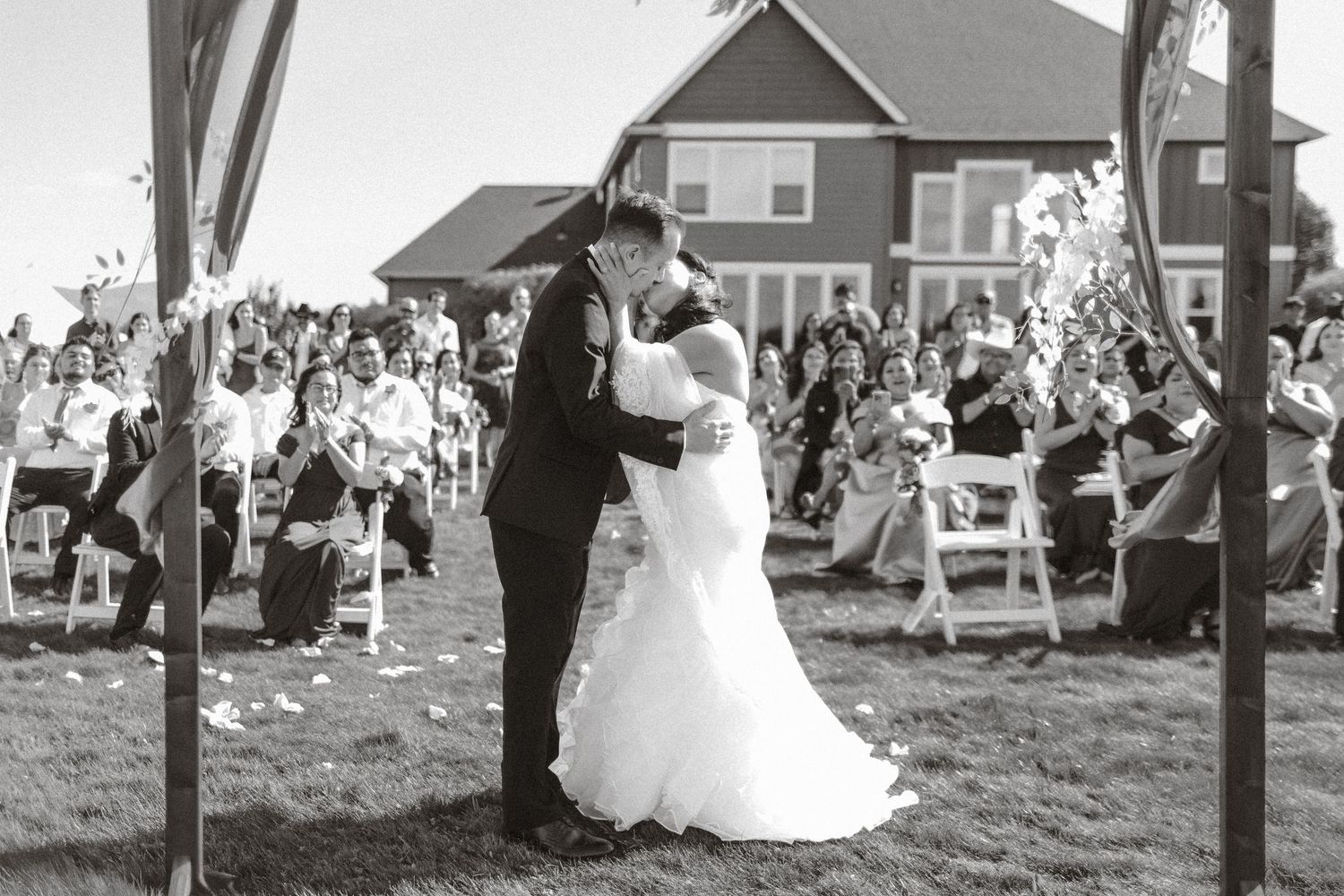 A sequence of black and white wedding photos showing romantic moments and dancing at an outdoor reception.