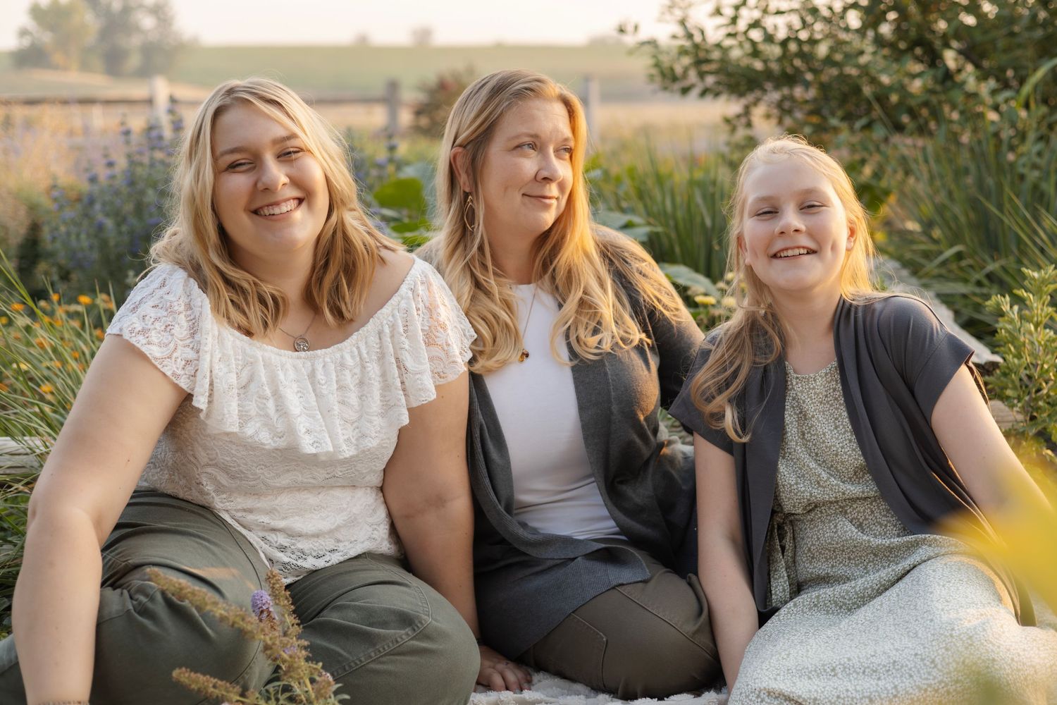 Group sitting together outdoors in casual summer attire.