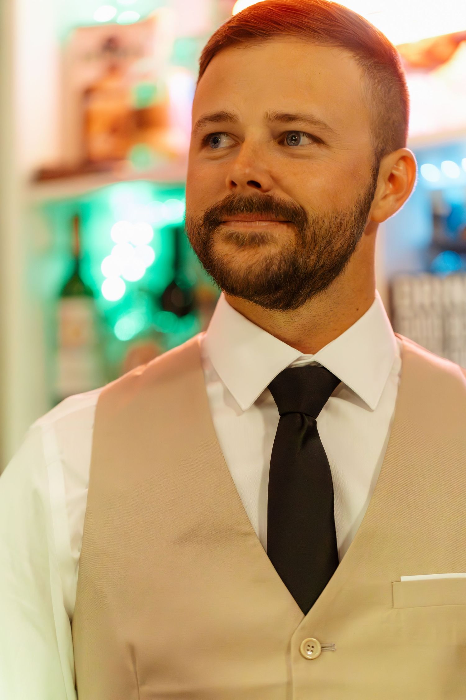 A series of candid expressions showing a man in a white dress shirt and black tie smiling warmly at different angles.