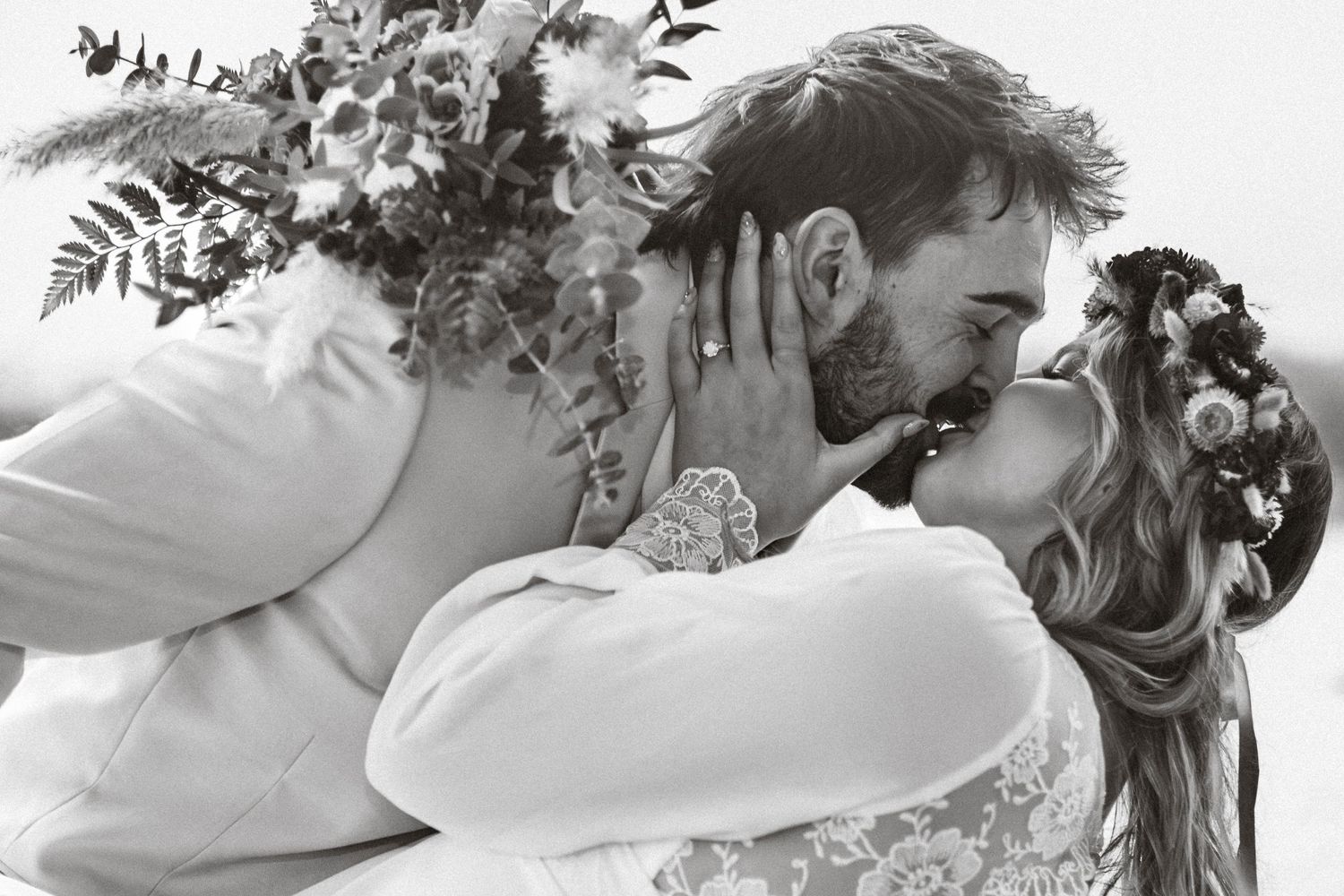 Romantic black and white wedding photo with floral decor.
