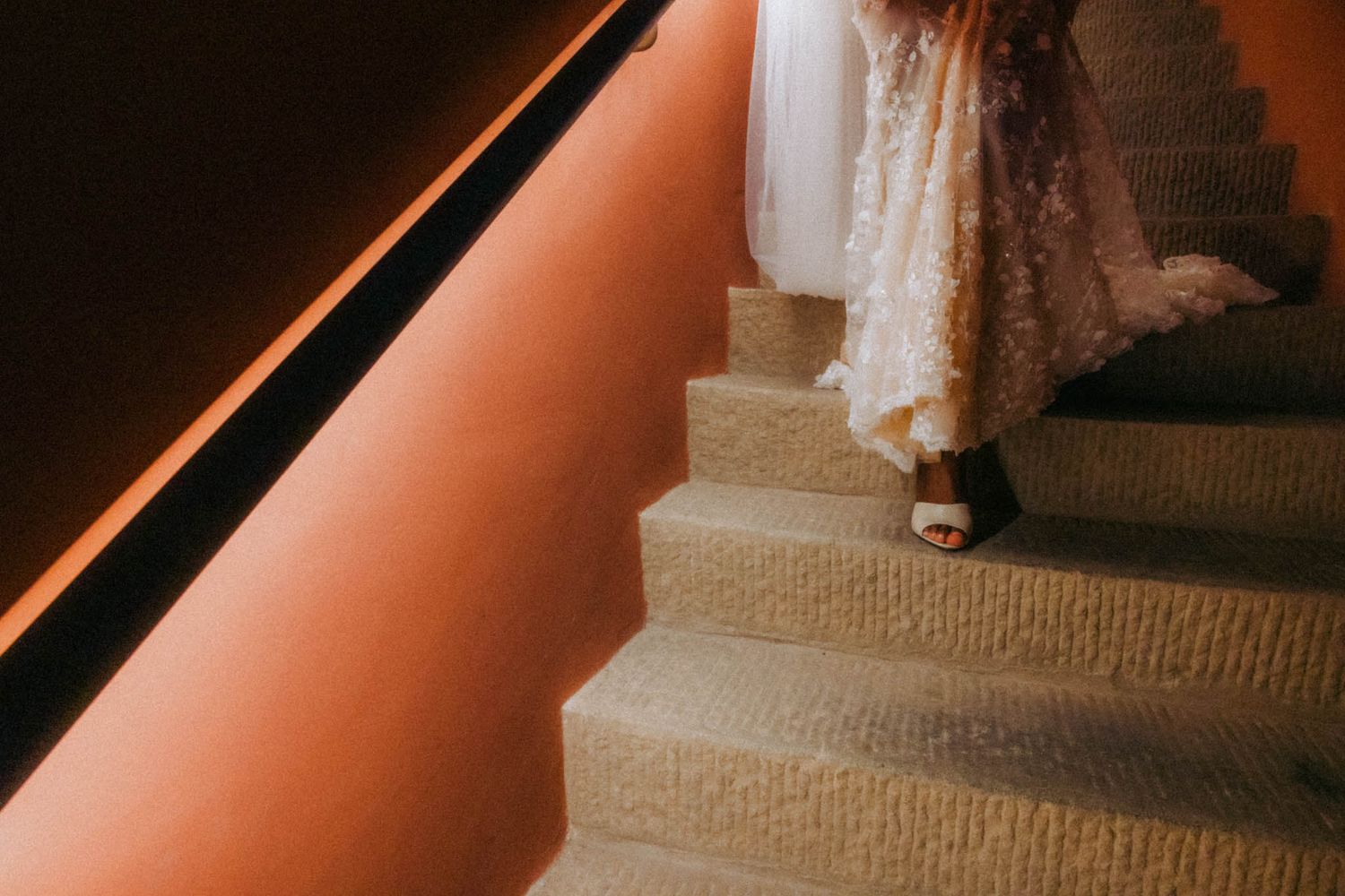 A series of wedding photos showing a bride in a white dress walking down a carpeted aisle at an indoor ceremony.