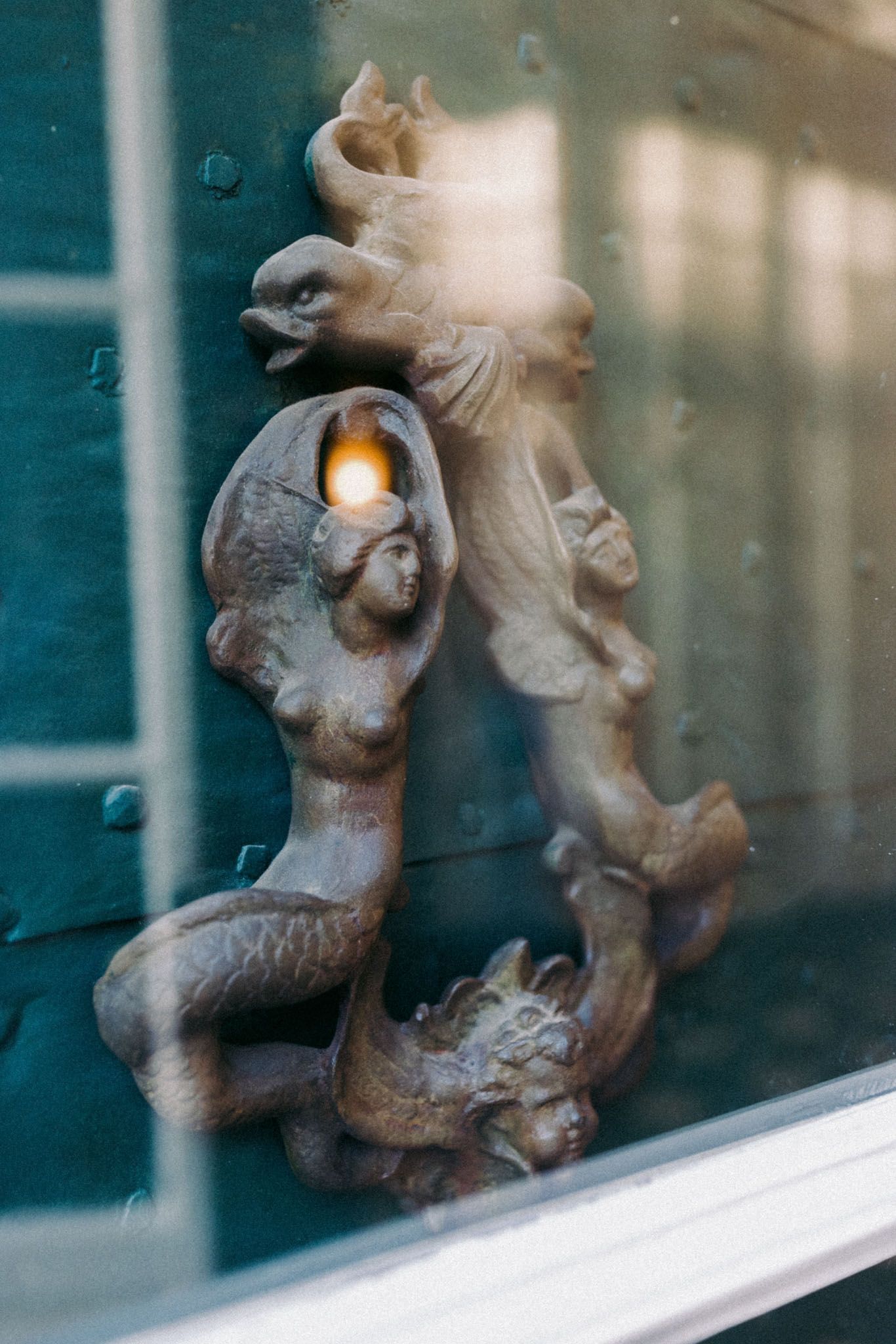Decorative metal squirrel sculptures mounted along a window ledge creating a playful silhouette display.