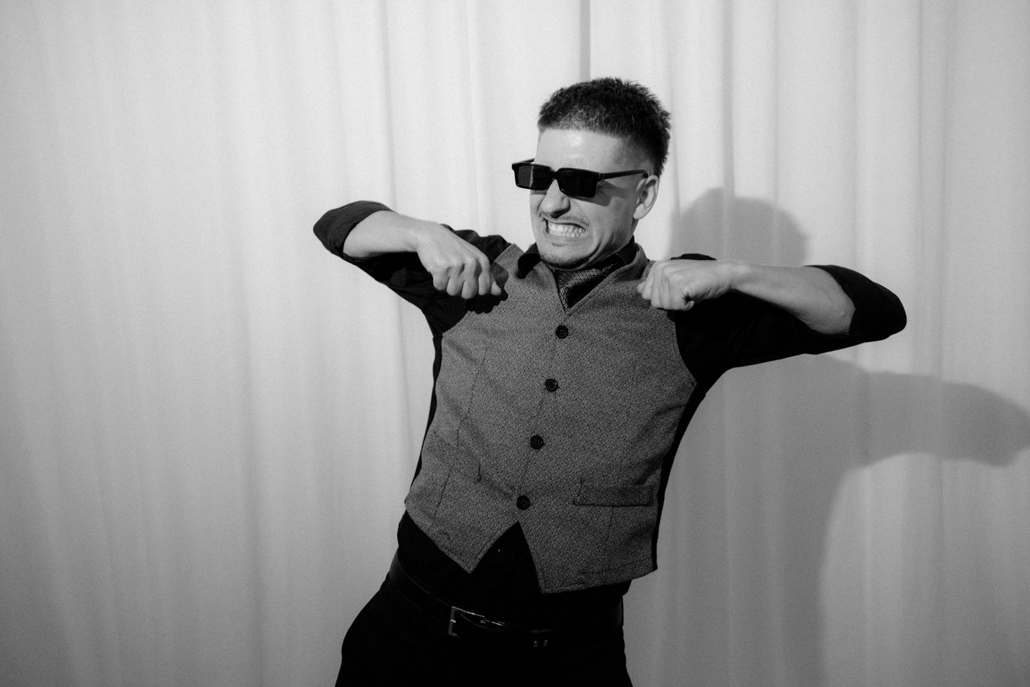 A series of black and white photos showing someone dancing and moving expressively against a plain backdrop.