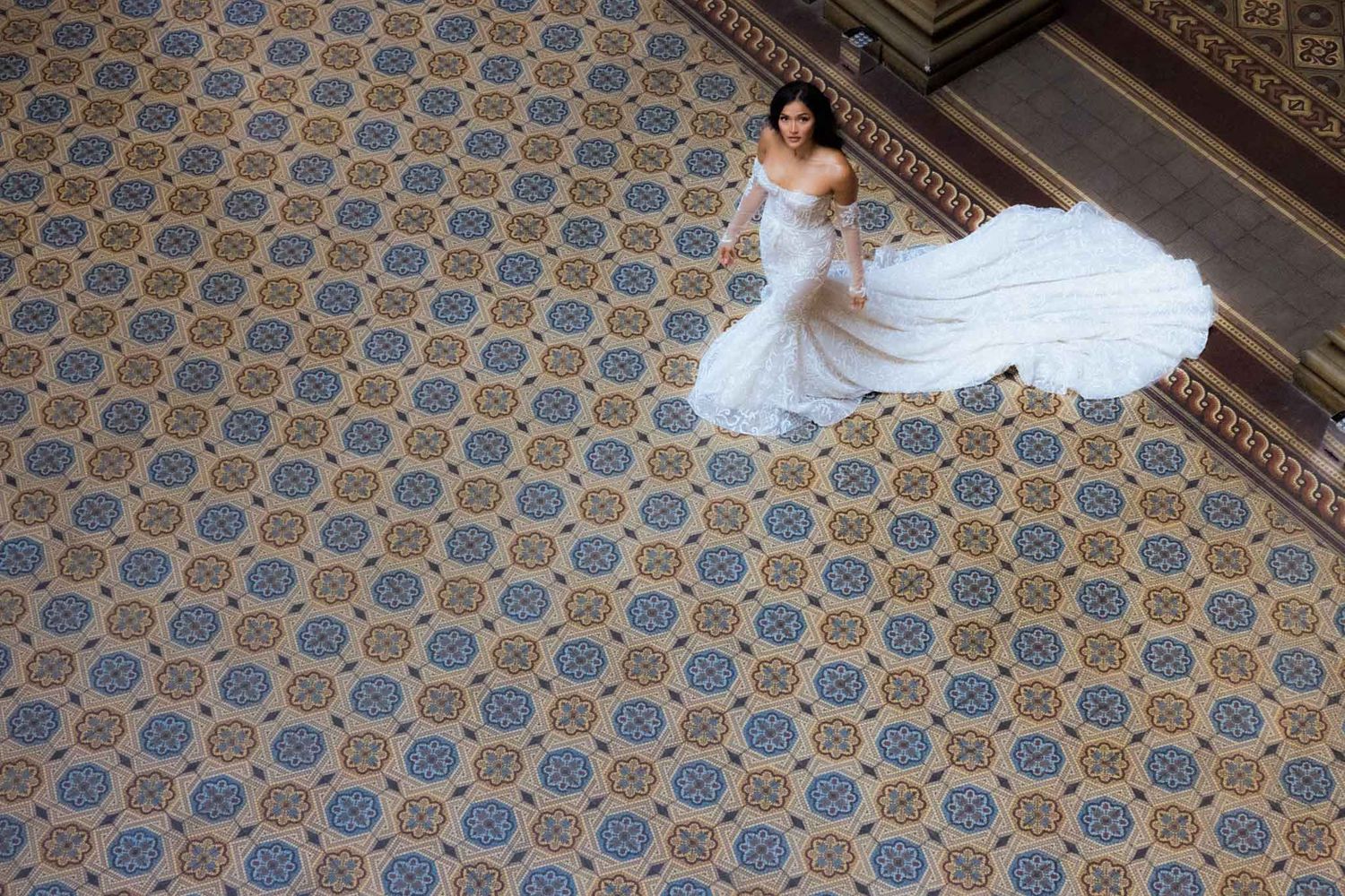 Wedding photos captured in a hallway with ornate hexagonal floor tiles and classical architectural details.