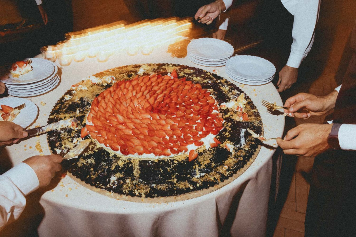 Four large colorful rice bowls arranged on a table with various toppings and garnishes being served.