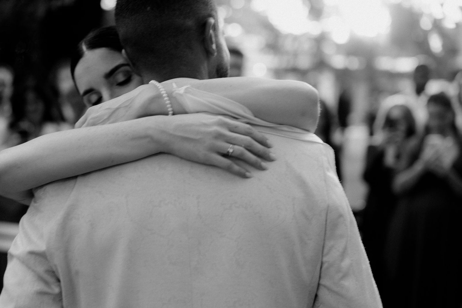 Black and white image of a couple dancing closely together at a social event.