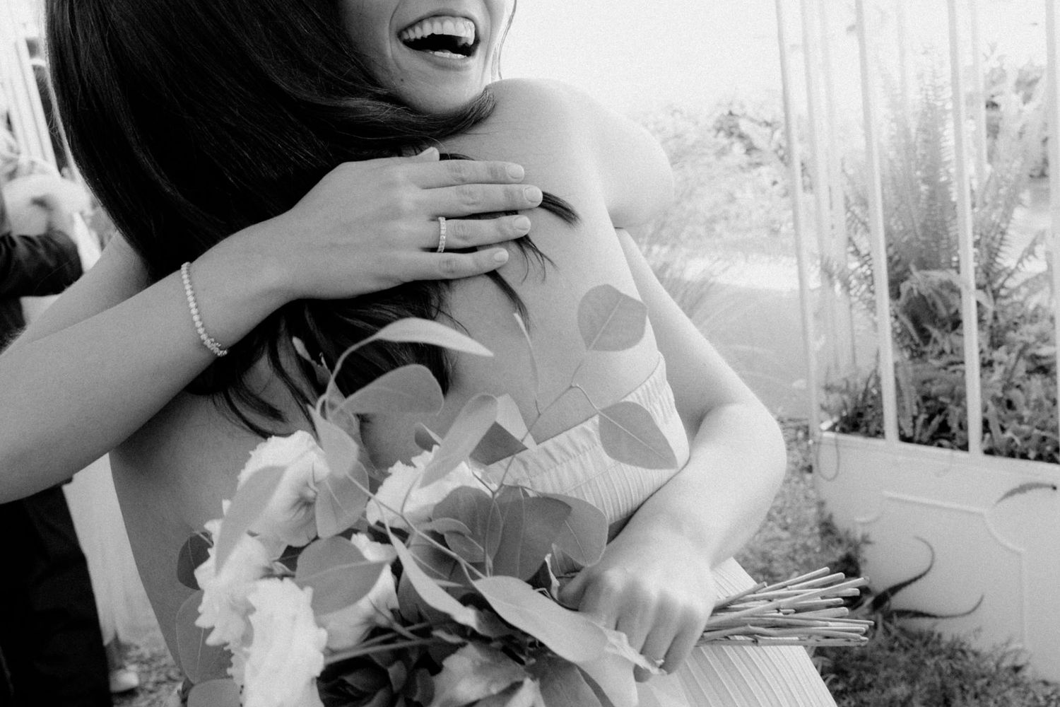A black and white photo collage showing joyful candid moments at what appears to be a wedding celebration.