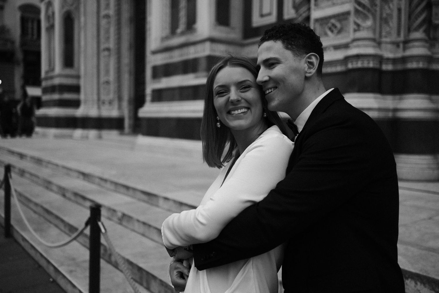 A series of black and white vintage wedding photos showing couples embracing on outdoor steps.