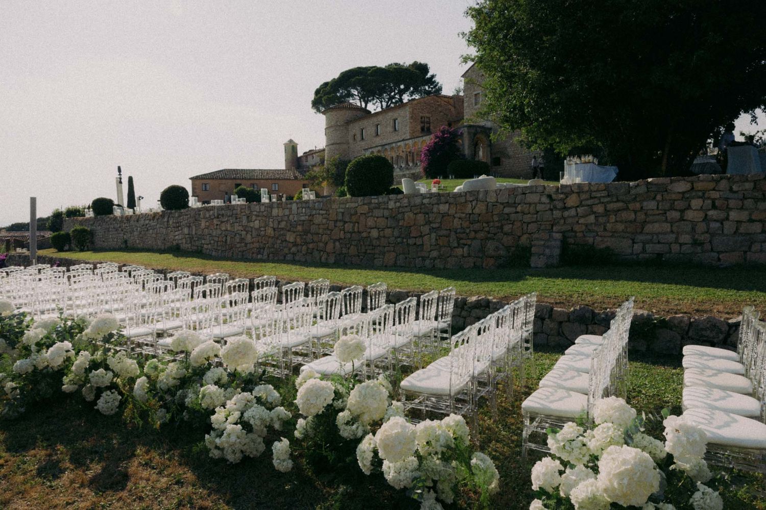 Rows of white military headstones stretch across a hillside cemetery at a national veterans memorial.
