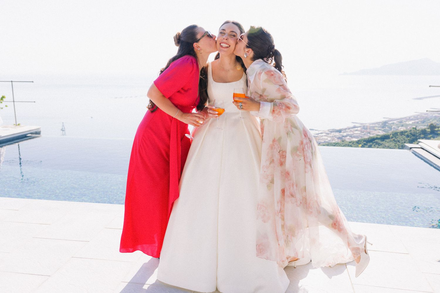 A romantic couple shares tender moments by the ocean in a series of wedding photos.