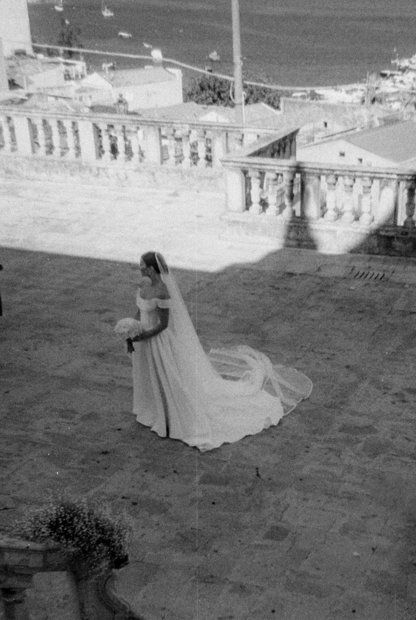 A black and white photo sequence shows a figure in flowing white dress twirling gracefully on a stone terrace.