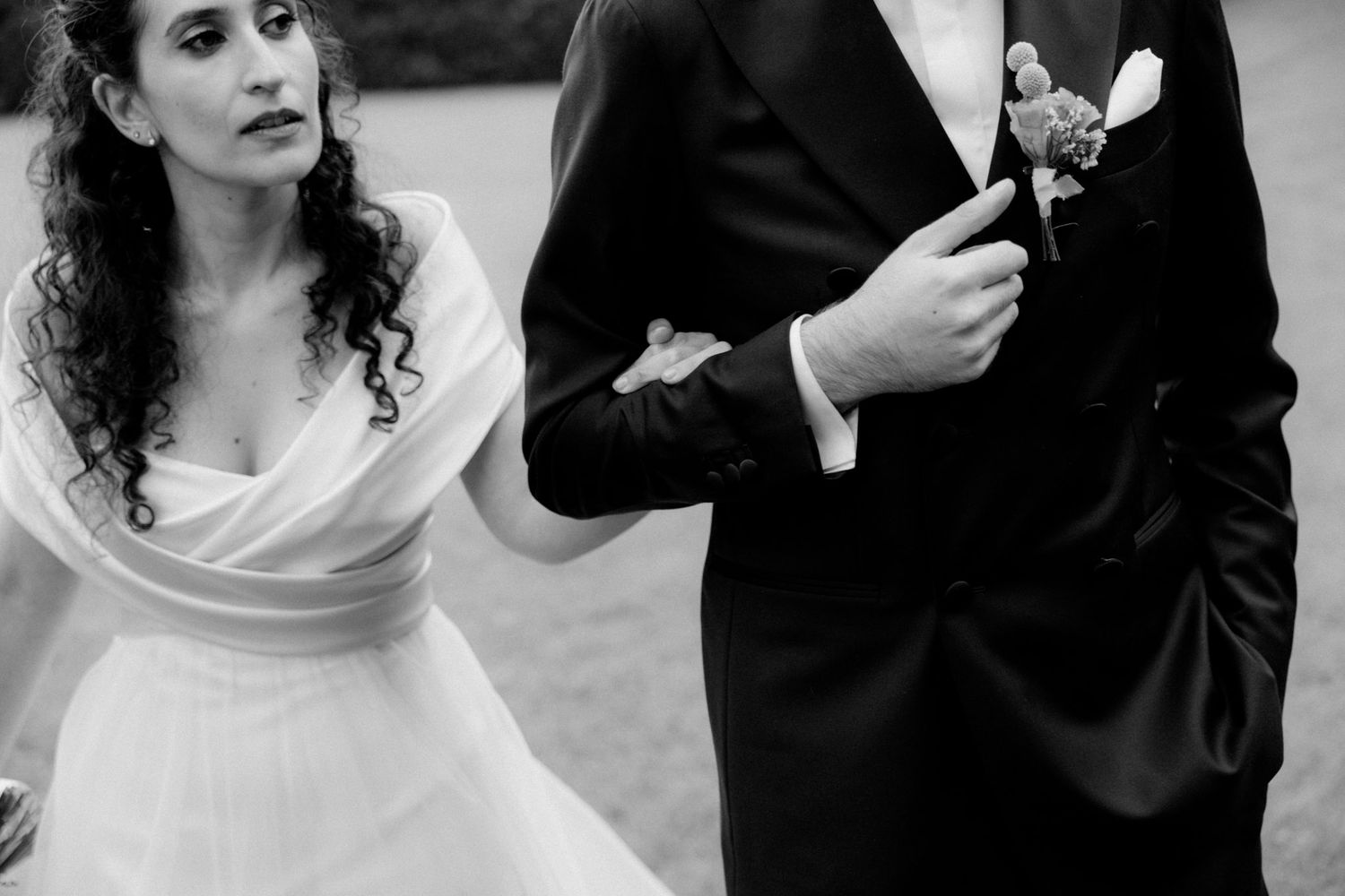 A bride and groom share a playful moment feeding each other ice cream cones in black and white photography.