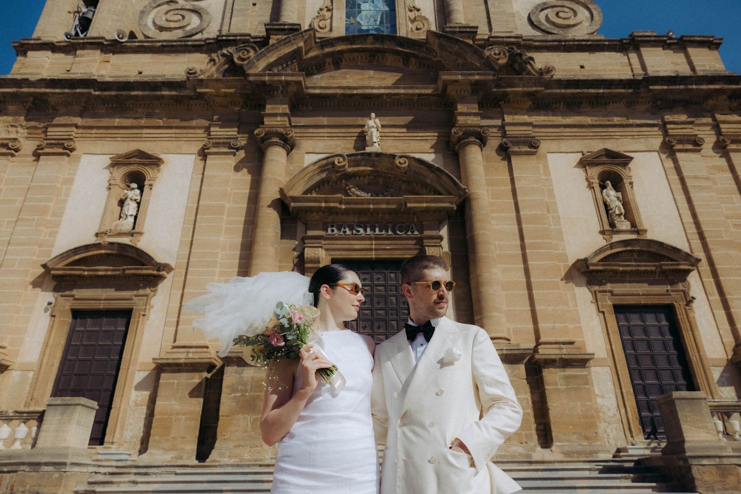 Ornate stone church facade with classical architectural details and decorative elements in a European style.