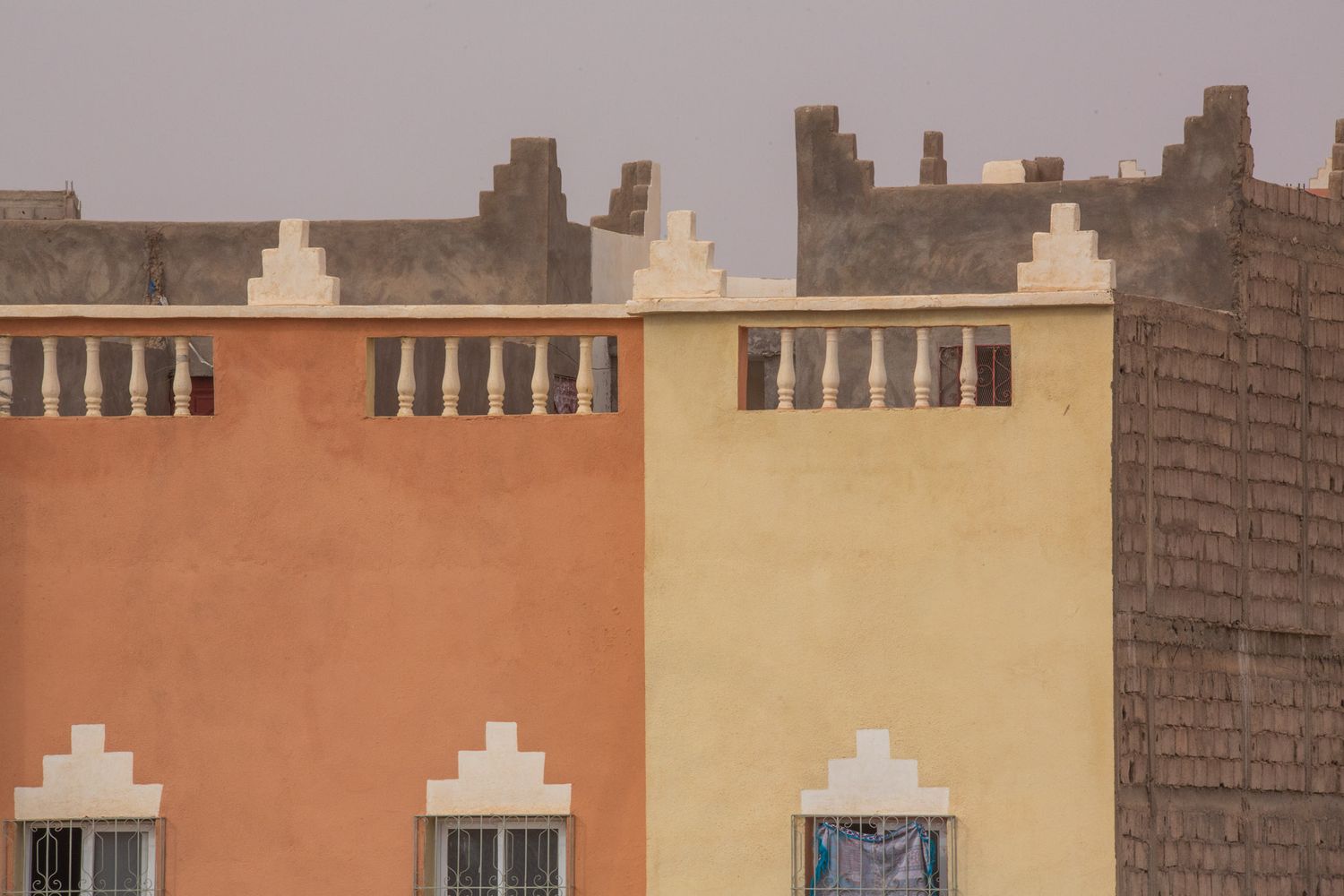 Colorful row of historic buildings with traditional European architecture and windows along a city street.