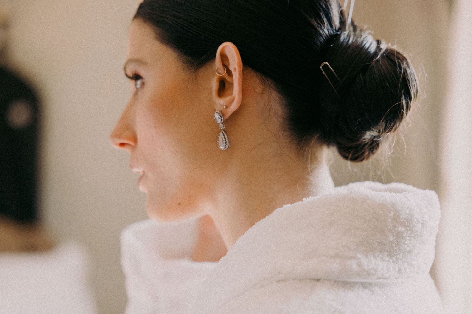 A collection of elegant bridal portraits showing delicate details of hair, jewelry and a white dress.