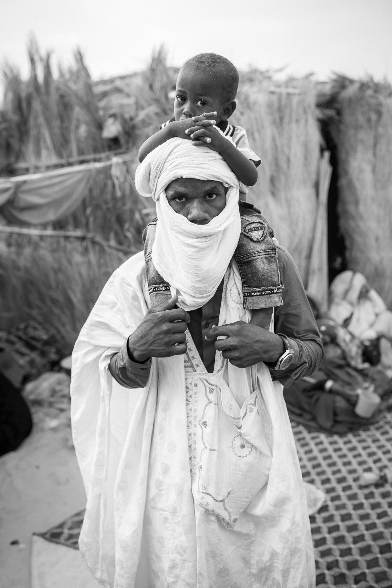 Series of black and white photos showing person demonstrating use of traditional mask.