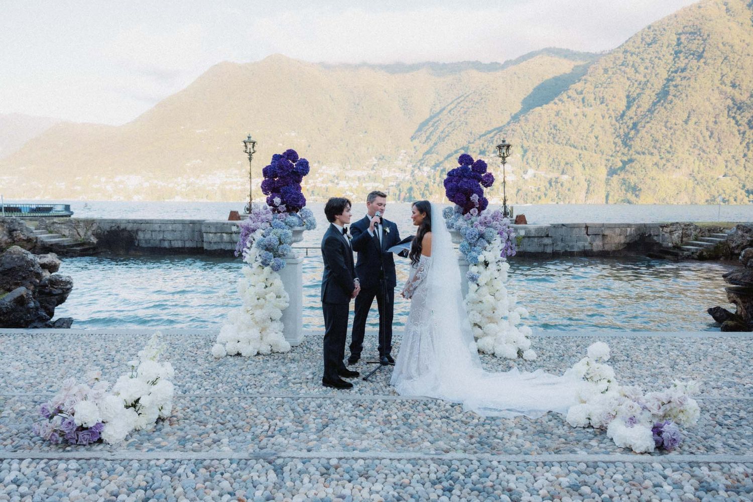 A series of six wedding photos showing a couple celebrating on a scenic beach with mountains in the background.
