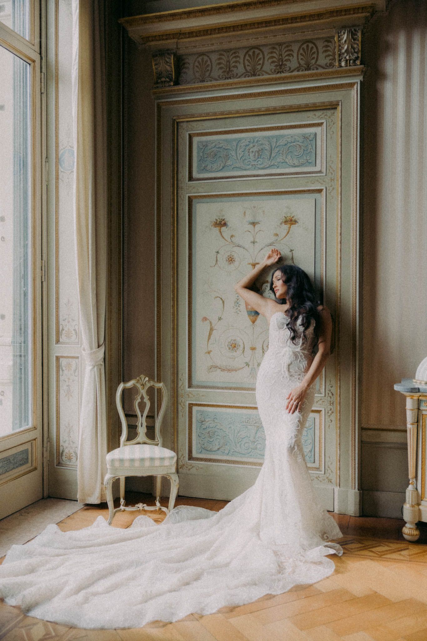 A romantic wedding scene unfolds in a luxurious room with ornate walls and flowing white gown details.