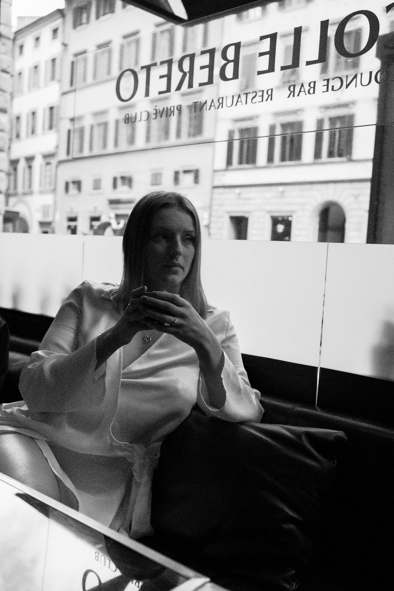 A black and white photo sequence shows a person sitting in a cafe window, captured in multiple reflective angles.