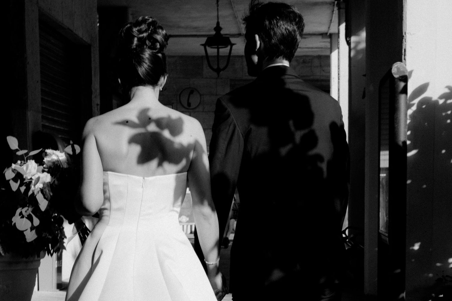 A black and white photo of a couple dancing together during their wedding reception celebration.