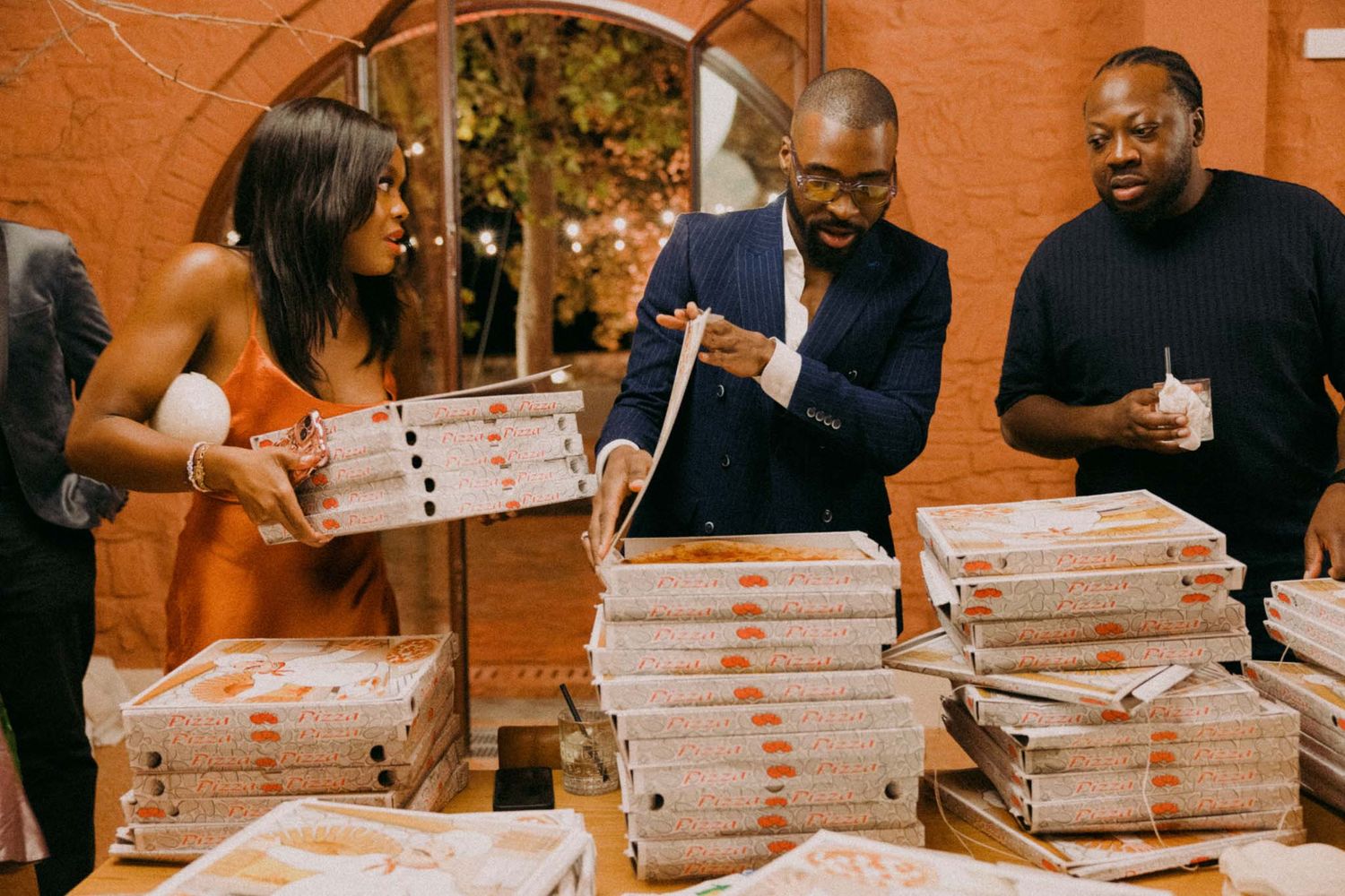 A sequence of photos showing people signing stacks of papers and documents at a wooden table.