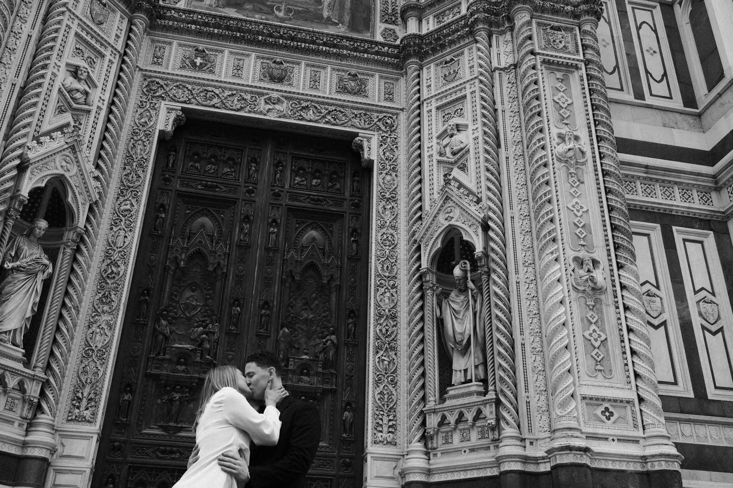 Architectural details of the Florence Cathedral's ornate Gothic facade with intricate stone carvings and sculptures.