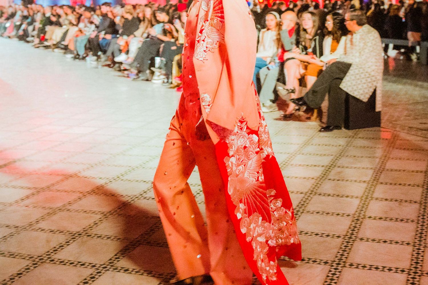 Traditional Chinese dancers perform in vibrant red costumes during a cultural celebration.
