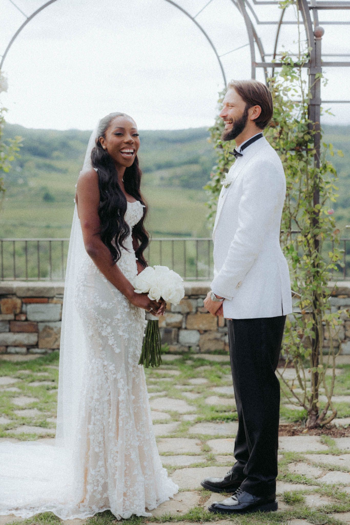 A series of candid wedding photos showing a couple sharing joyful moments on a stone patio with scenic views.