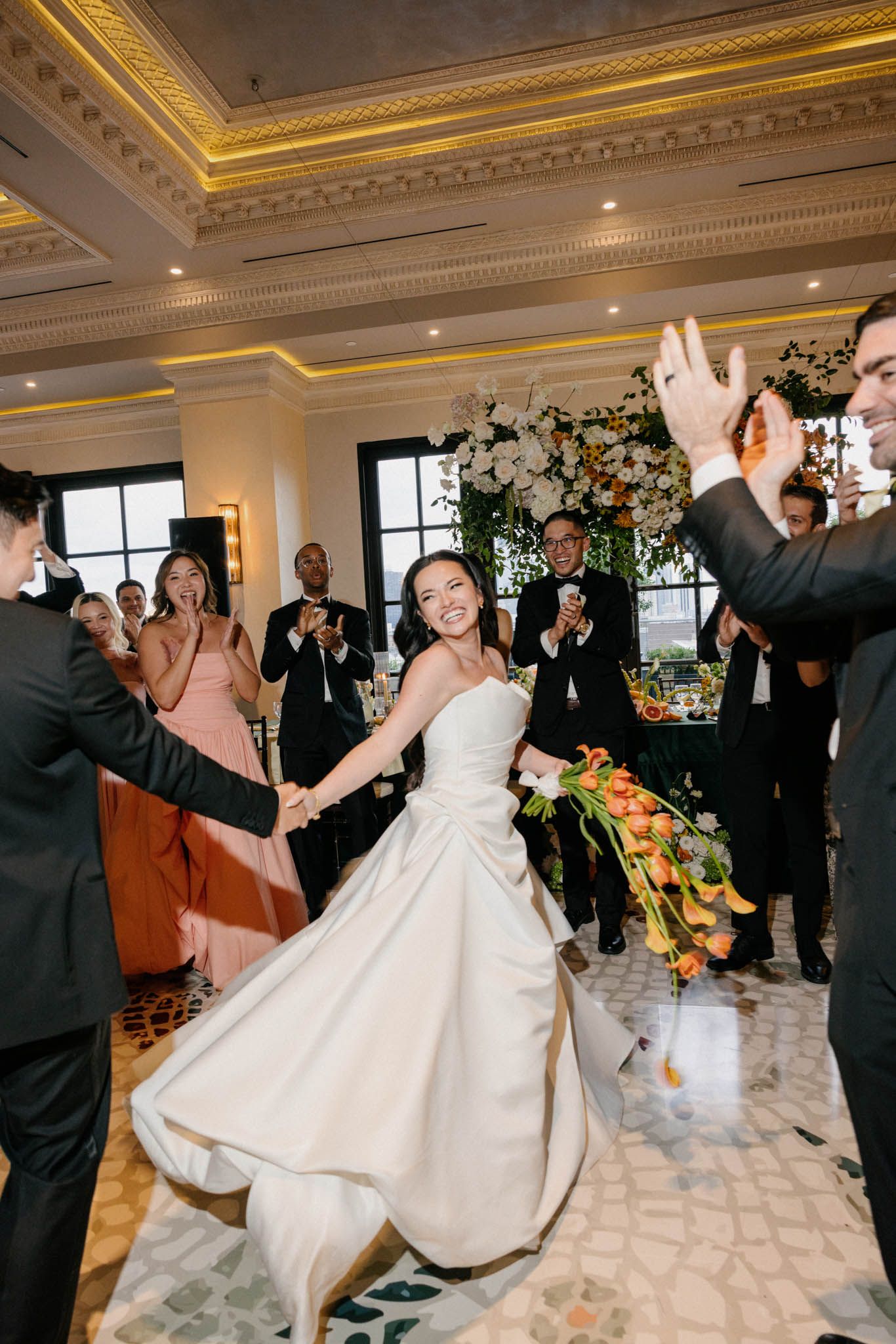 A sequence of wedding reception dance photos showing guests celebrating and dancing in an elegant ballroom with ornate decor.