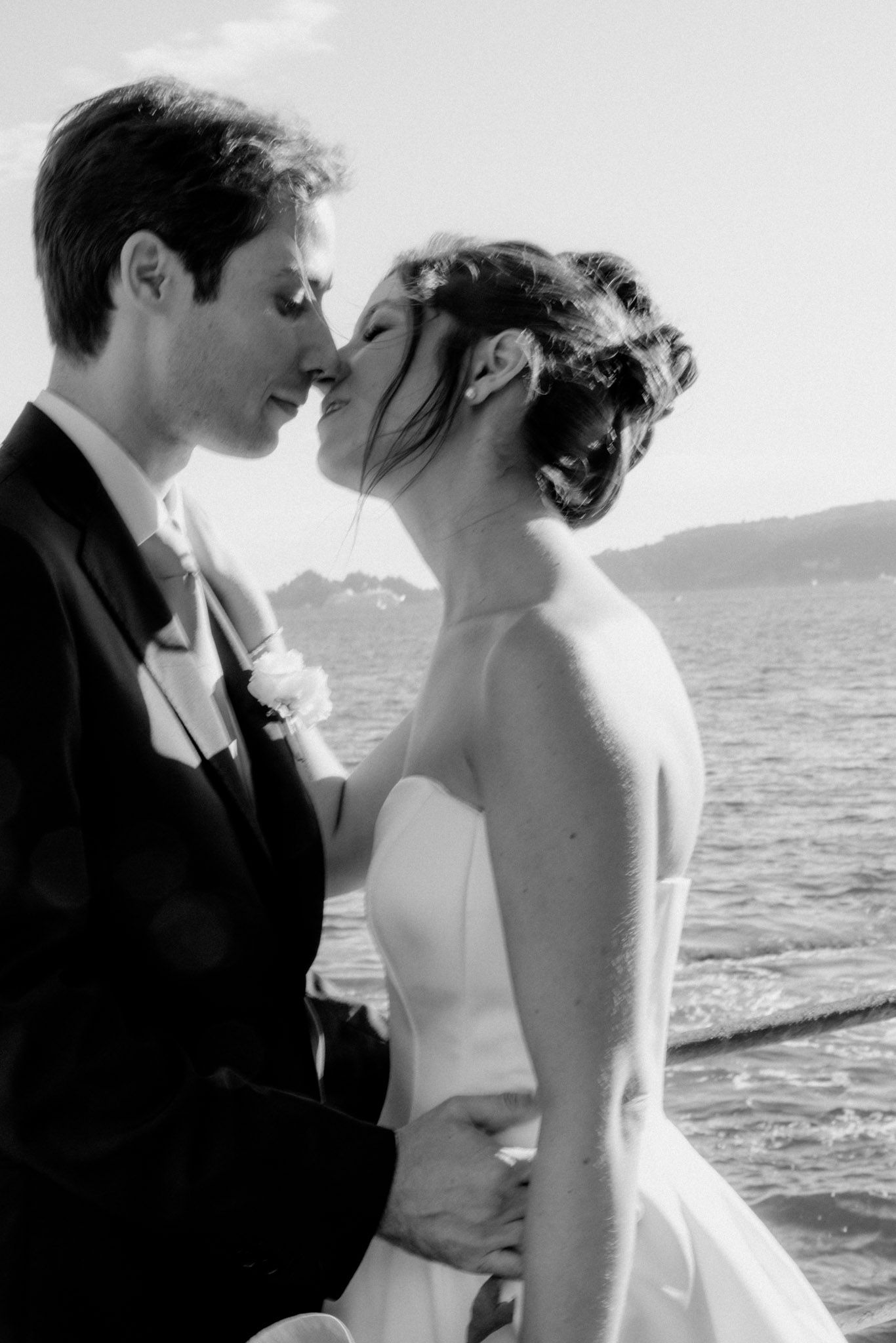 A sequence of romantic seaside wedding photos in black and white with ocean views in the background.
