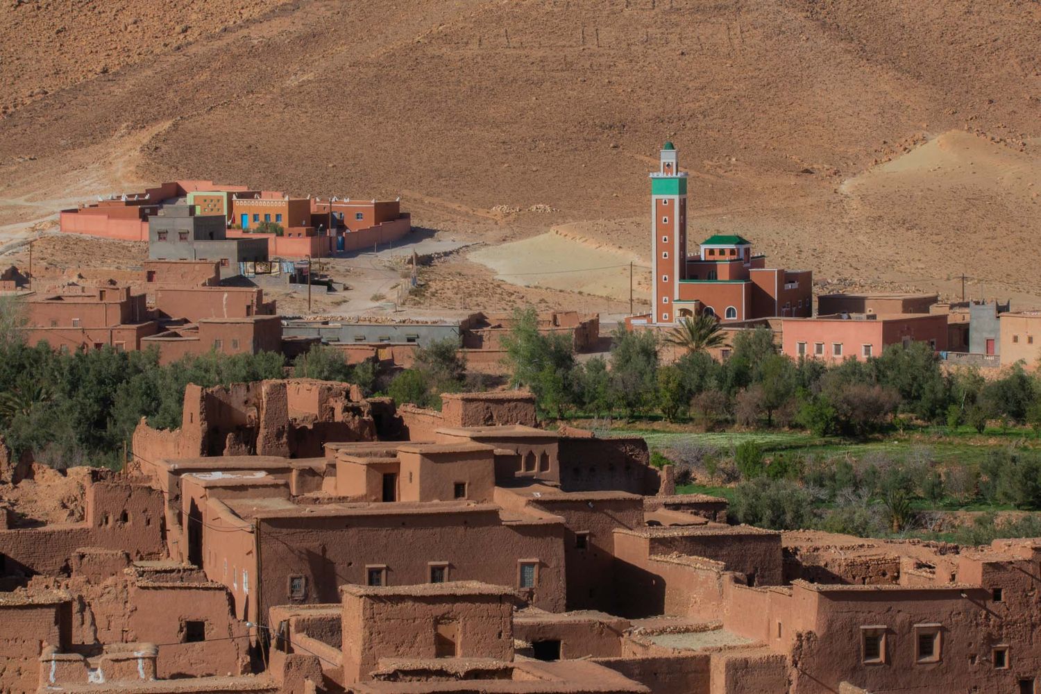 Traditional adobe buildings and architecture nestled in the Atlas Mountains of Morocco create a scenic desert landscape.