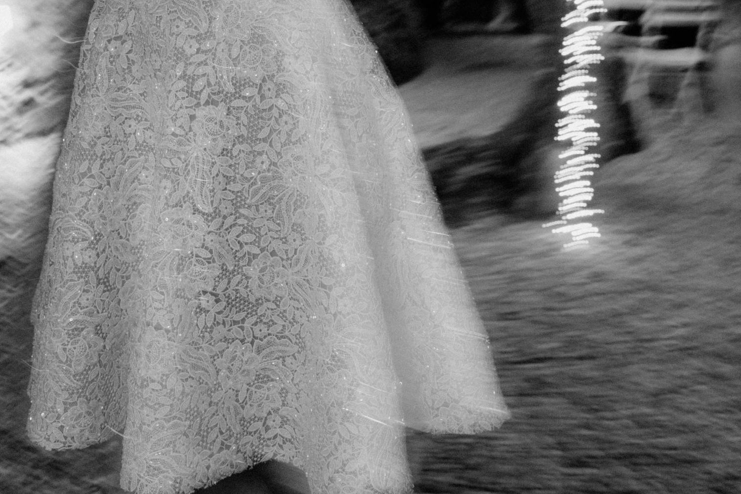 Black and white motion blur photograph of a lace dress swaying in the wind.