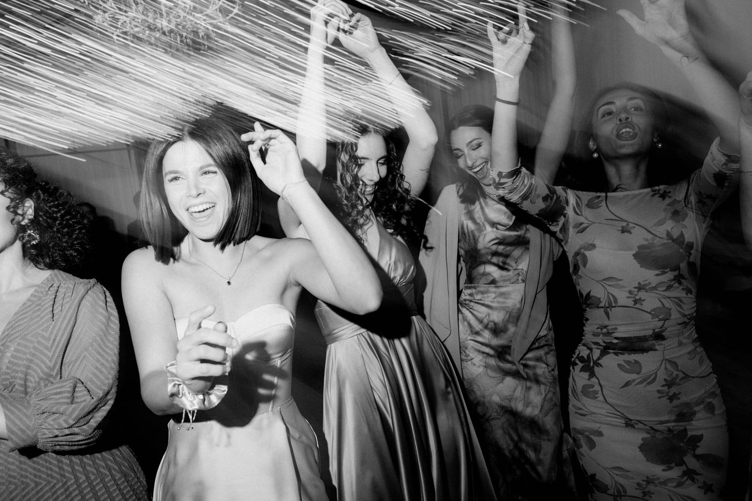 A series of black and white photos showing people dancing and socializing at what appears to be a party or nightclub.