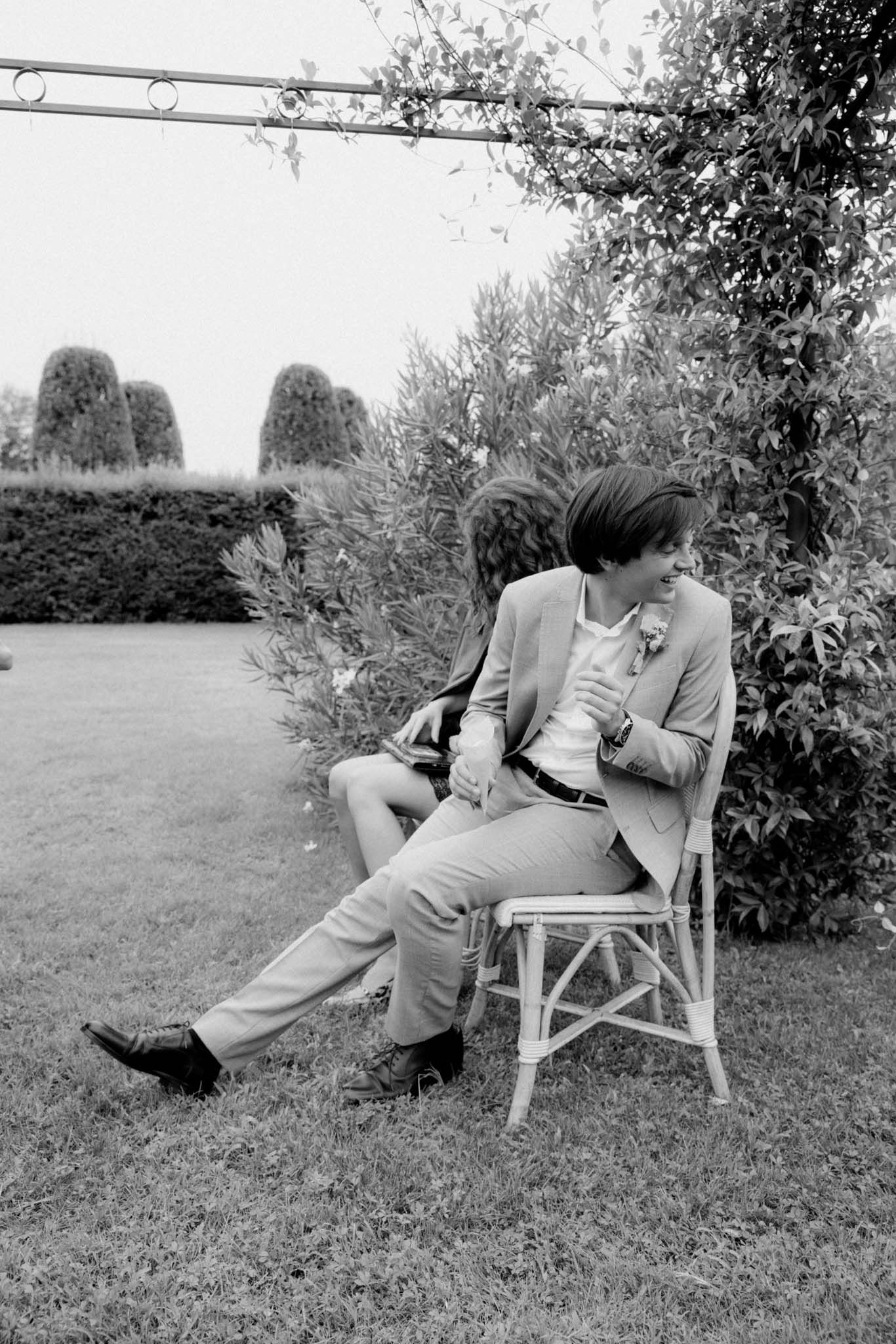 Black and white photo series of couple relaxing together on outdoor chairs in a garden setting.