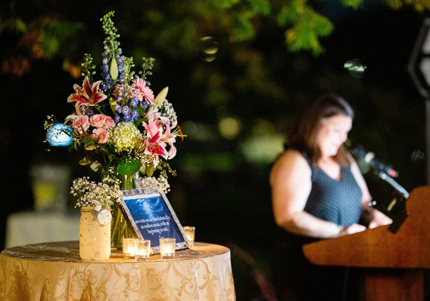Rustic wedding reception table details with floral centerpieces and decorative elements.
