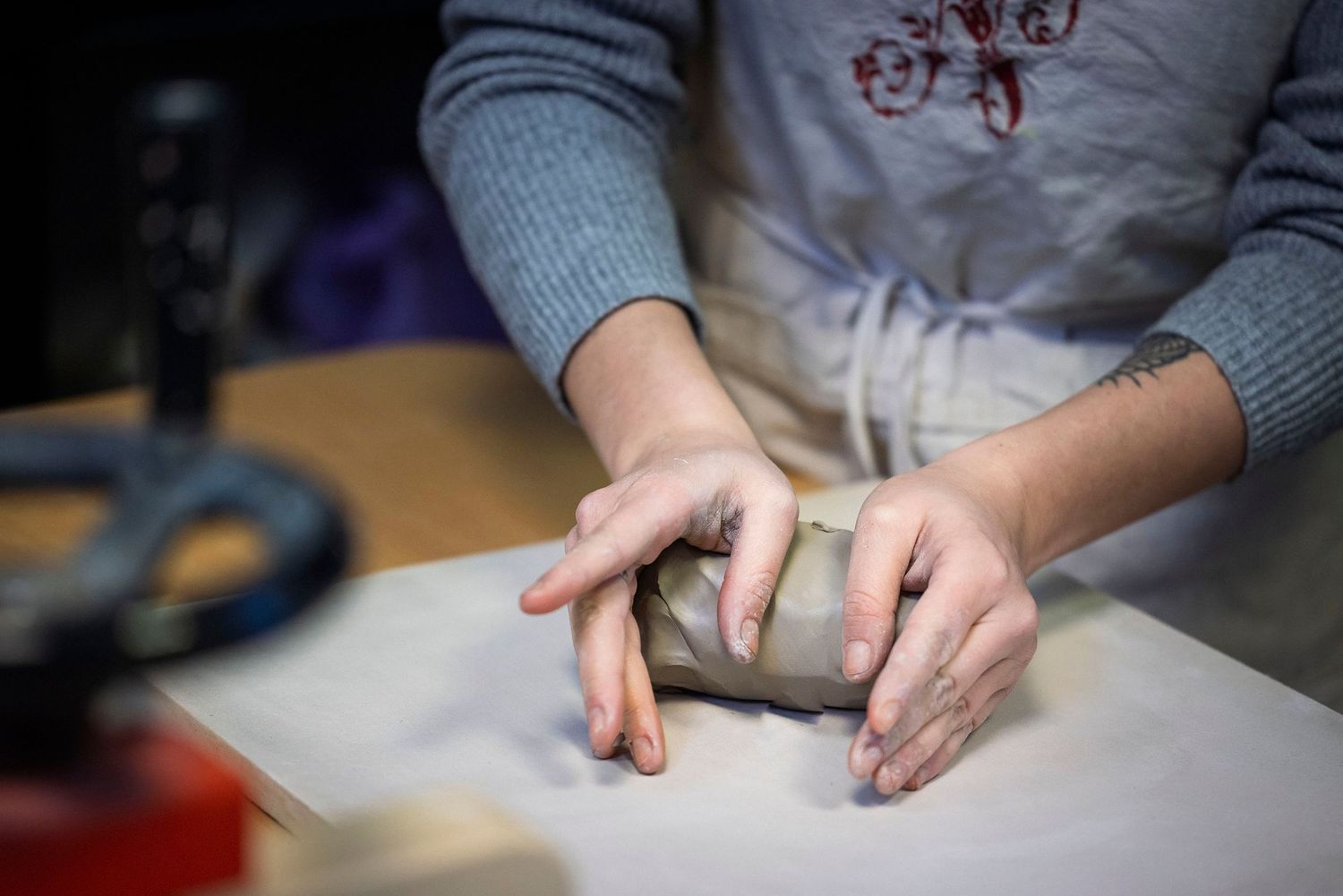 Hands working with clay on a white surface in an artistic workspace.Claire Bourguin Bourgain Bourgoin Bourquin - Photographe Bruxelles Belgi