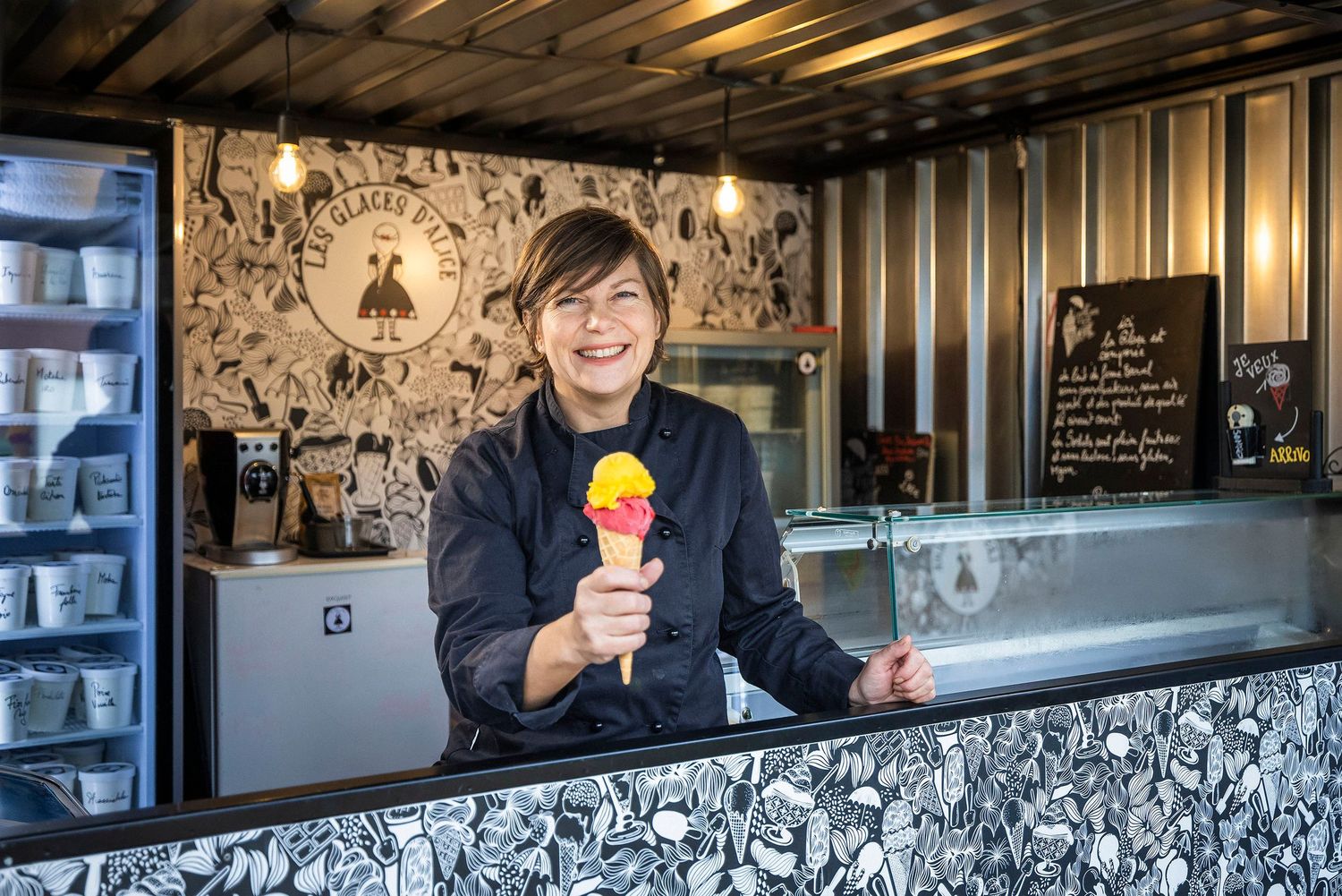 Modern ice cream shop counter with decorative black and white wall art and display case.Claire Bourguin Bourgain Bourgoin Bourquin - Photogr