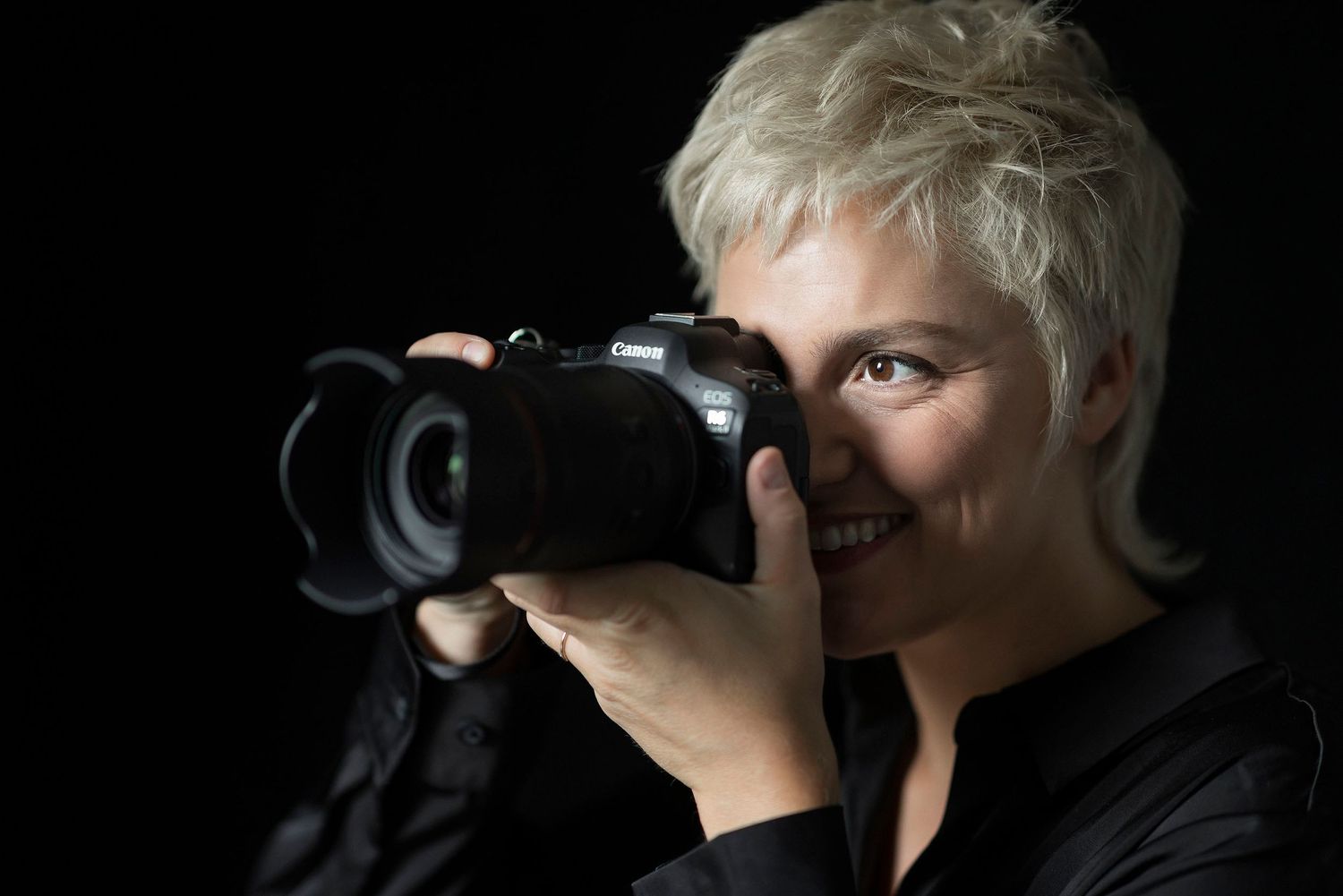 Silhouette series of photographer using camera against dark background.
