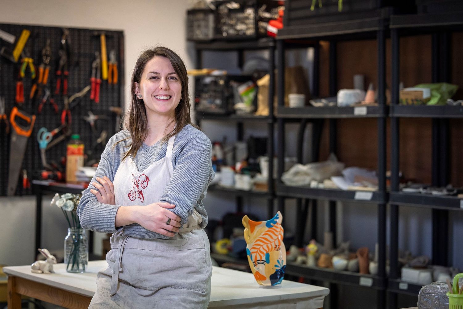 Creative workshop space with shelving units and crafting tools in background.Claire Bourguin Bourgain Bourgoin Bourquin - Photographe Bruxel