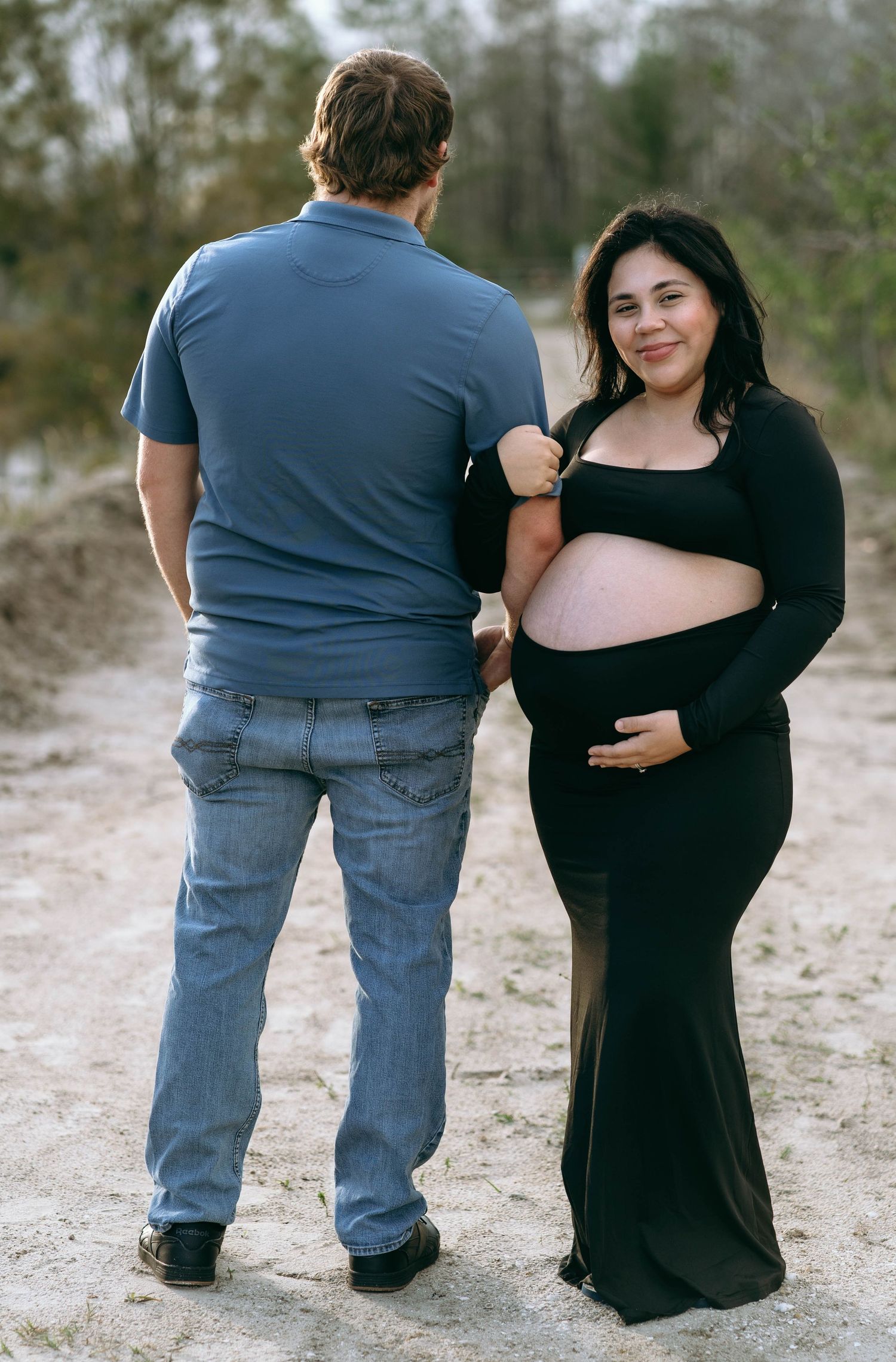 A series of photos showing a couple sitting together on sandy ground in casual attire.