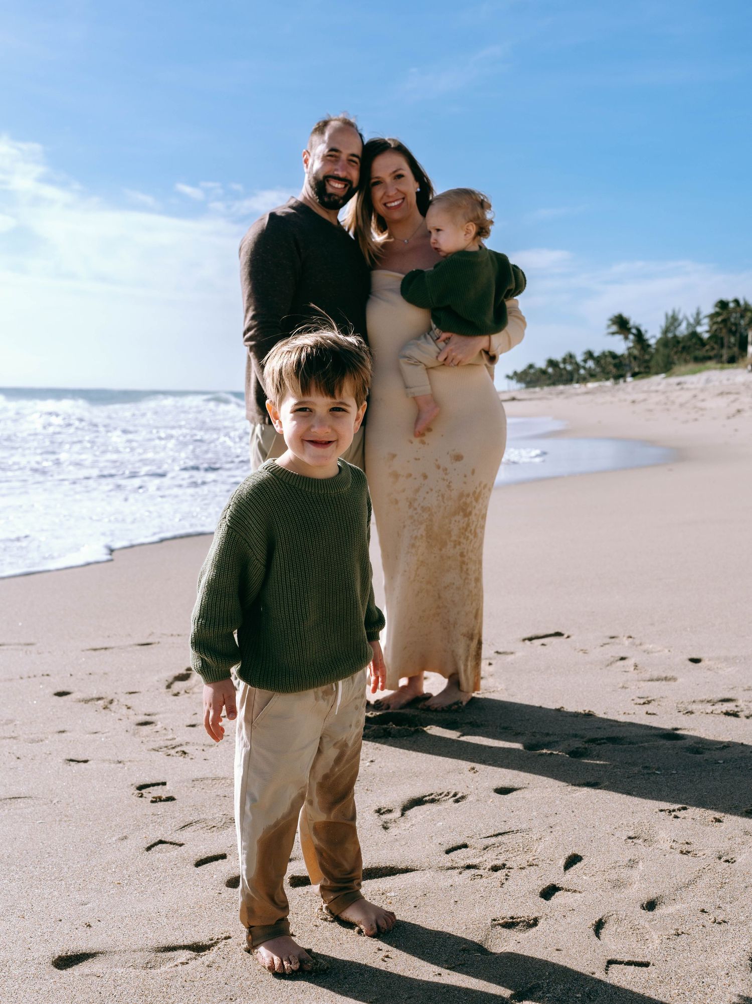 Candid moments of family playing and running on sunny beach.