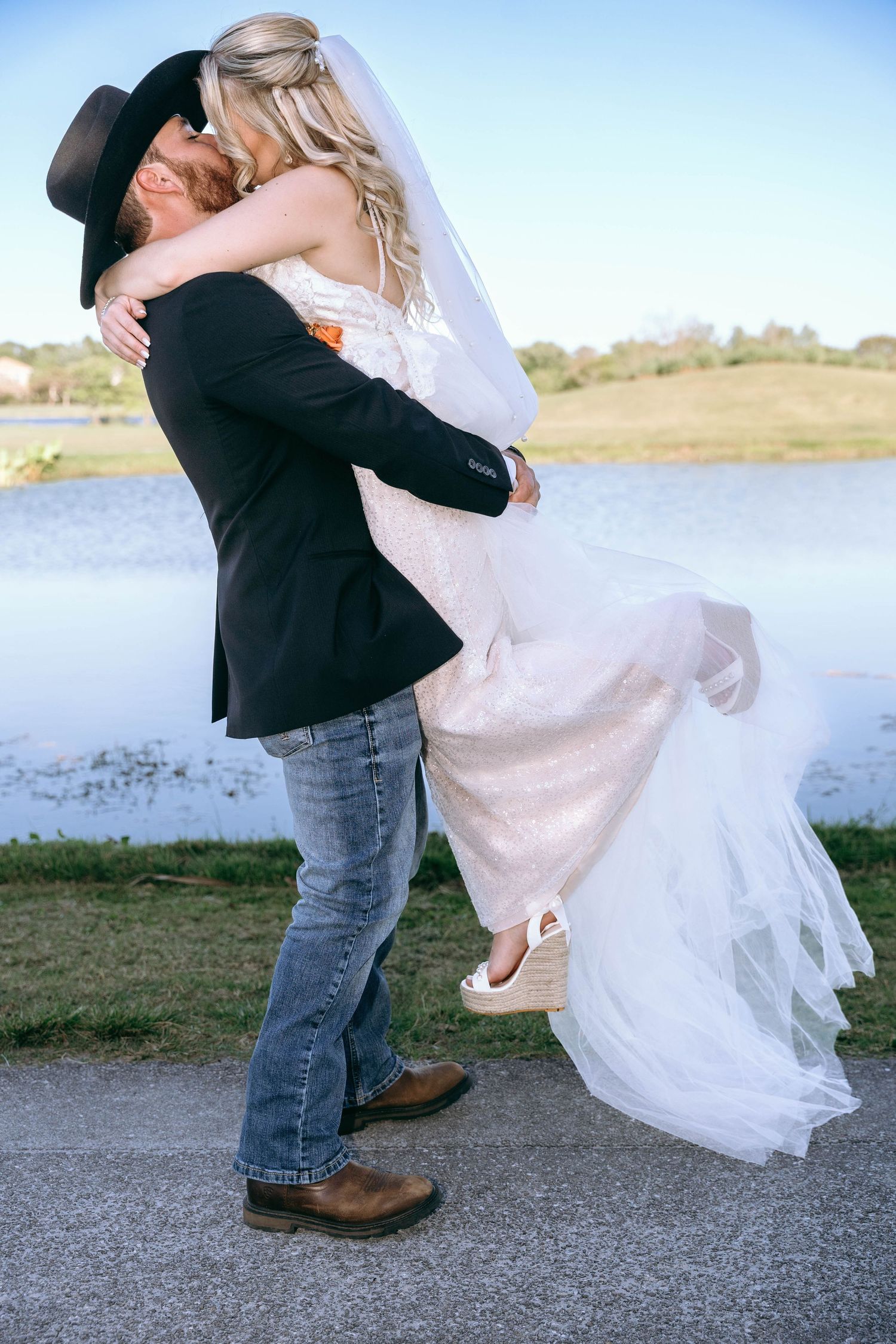 A series of romantic wedding photos showing a couple dancing by a lake with flowing white dress and cowboy boots.