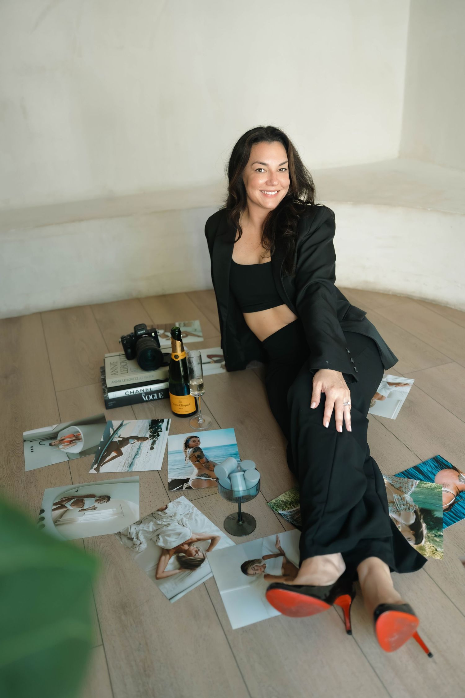 Lifestyle photoshoot on wooden floor with magazines and drinks scattered artistically.