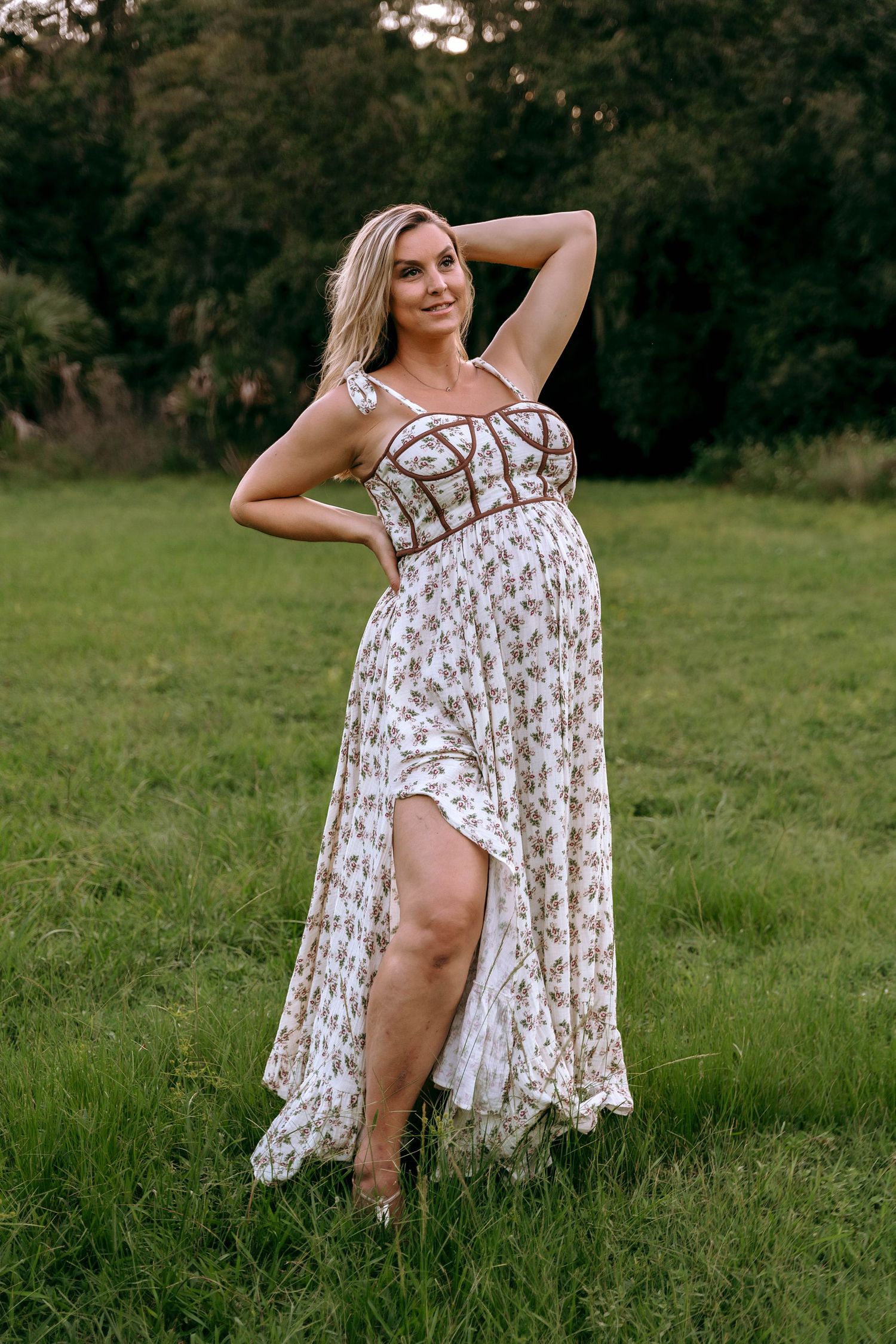 A white summer dress catches the evening light in an artistic outdoor photoshoot.