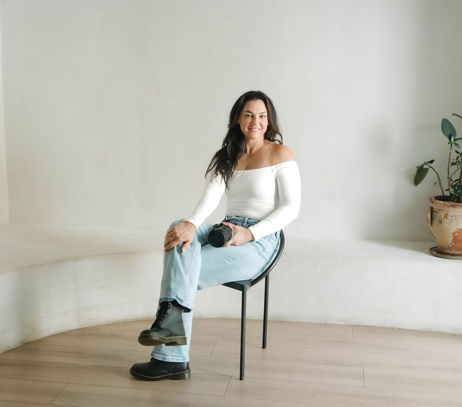 Figure in casual attire strikes dynamic poses in a bright, minimalist studio setting.