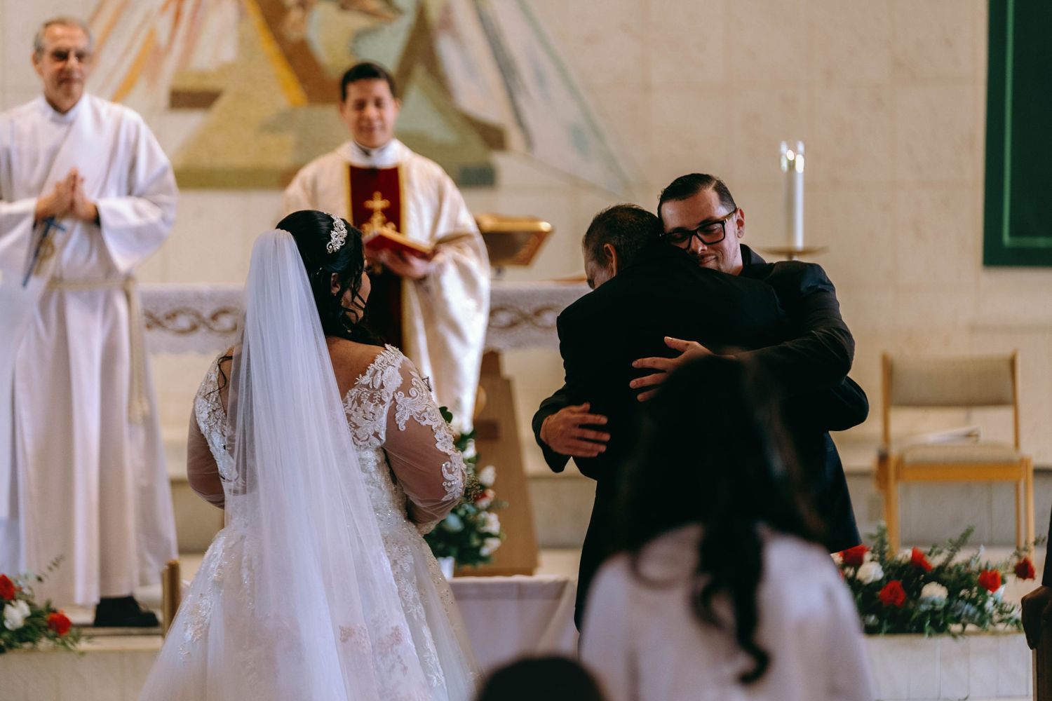 An emotional moment during a church wedding ceremony with guests watching.
