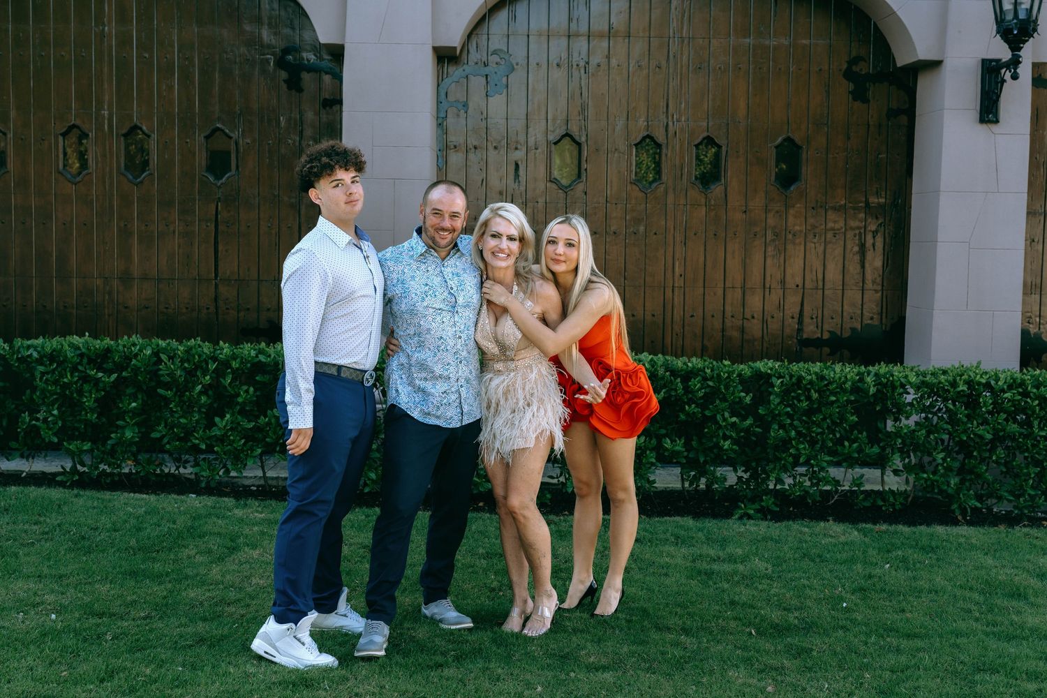 Family and friends gathered for photos in front of an ornate architectural backdrop.